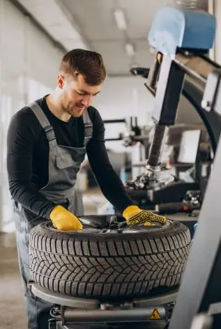 Technician repairing alloy wheel using professional tools