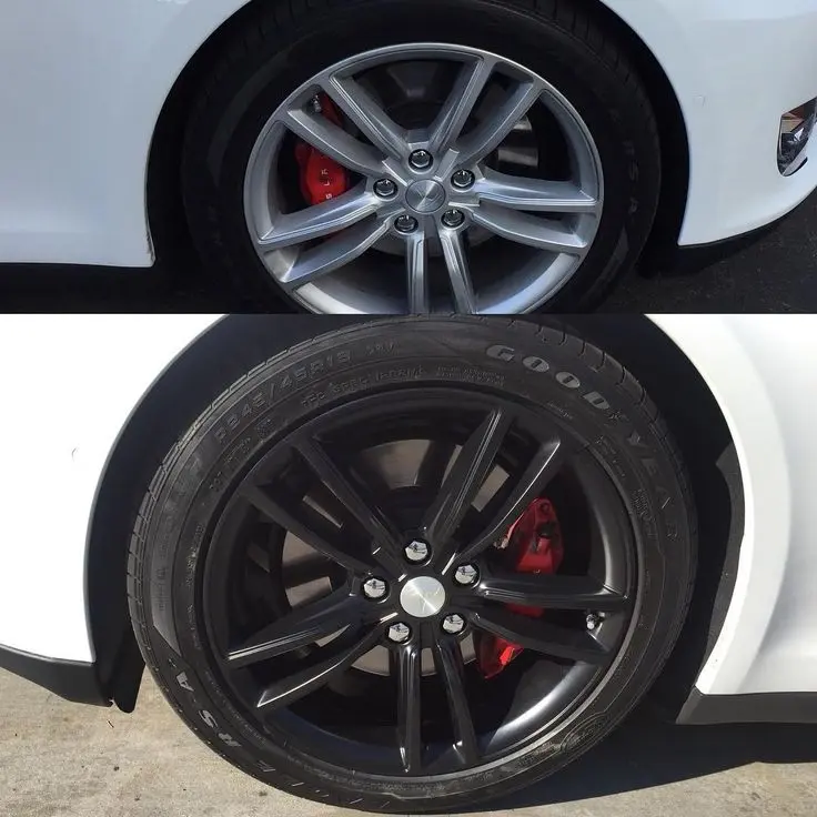 Alloy wheel being powder coated using professional equipment
